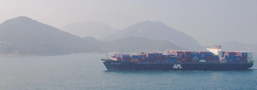 Loaded container ship near islands